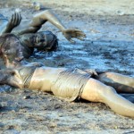 photo of two people mud wrestling