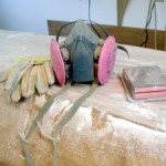 photo of respirator, gloves, and a sanding block
