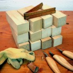 photo of a dozen basswood blocks and woodcarving tools