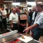 photo of Roy Underhill demonstrating SawStop technology with a piece of fried chicken