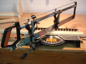 photo of a metal miter box and saw