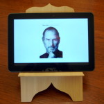 photo - 18th century stand - 21st century book (Steve Jobs on a Kindle)
