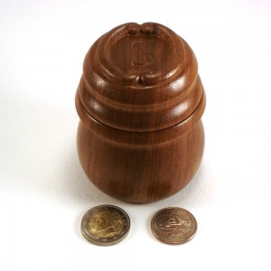 photo of a turned walnut box with monogrammed lid