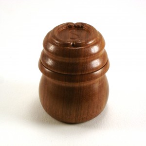 photo of a turned walnut box with monogrammed lid