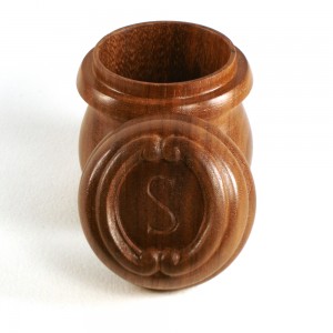 photo of a turned walnut box with monogrammed lid