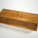 photo of a pencil box made of cherry with the initials H E P carved in the lid