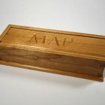 photo of a pencil box made of cherry with the initials M A P carved in the lid