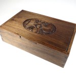 photo of a walnut box with an oval rose carved in the lid