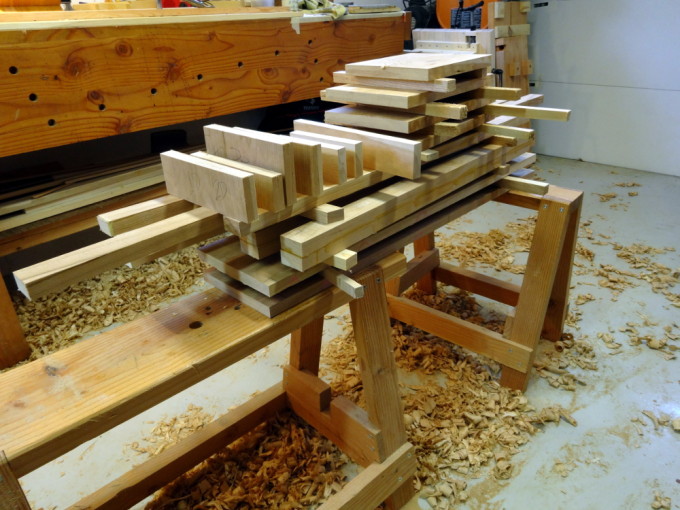 a stack of about 35 rough cut pieces of wood