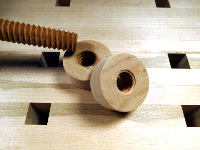 photo of wooden screw and two wooden nuts