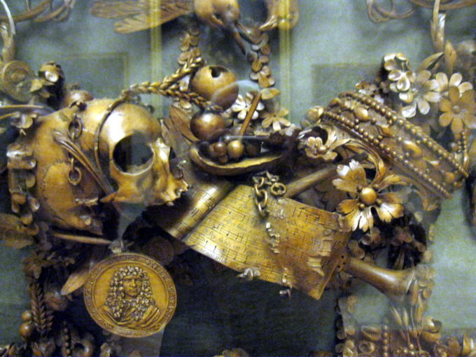 closeup photo of the central detail from the Modena panel - skull, instruments, crown and medallion